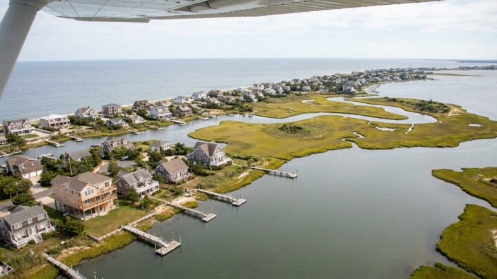 Aerial view of South Shore coastal homes showing elevated waterfront properties and barrier island development
