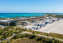 Regional airport terminal with aircraft and coastal Florida landscape