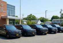 Suffolk County police patrol vehicles lined up at law enforcement facility