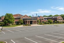 Long Island high school building exterior showing main entrance and campus grounds